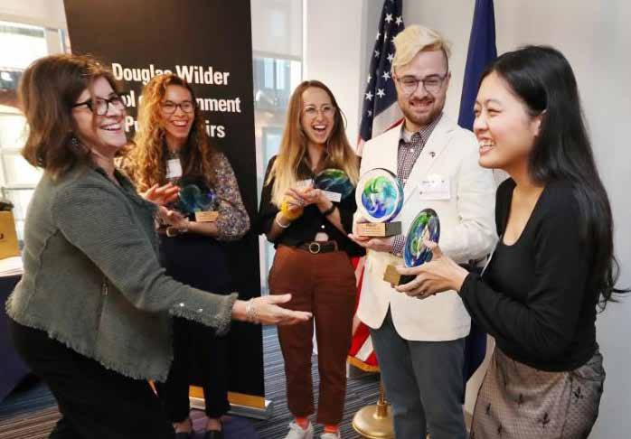 Nadya shaking hands and receiving an award