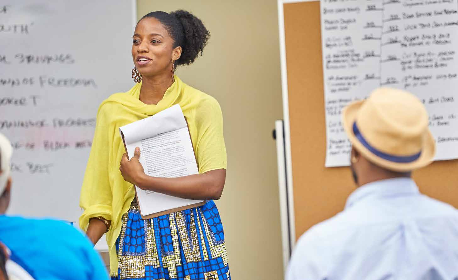 Najmah Thomas standing at the front of a classroom teaching