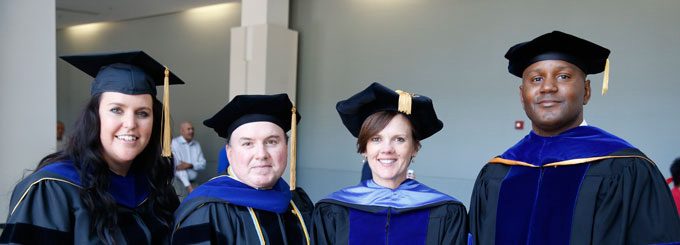 Sarah Jane Brubaker, Ph.D., director of the Wilder Schools doctoral program (second from right), enjoys graduation with Katherine Hall, Jose Alcaine and LeQuan Hylton.