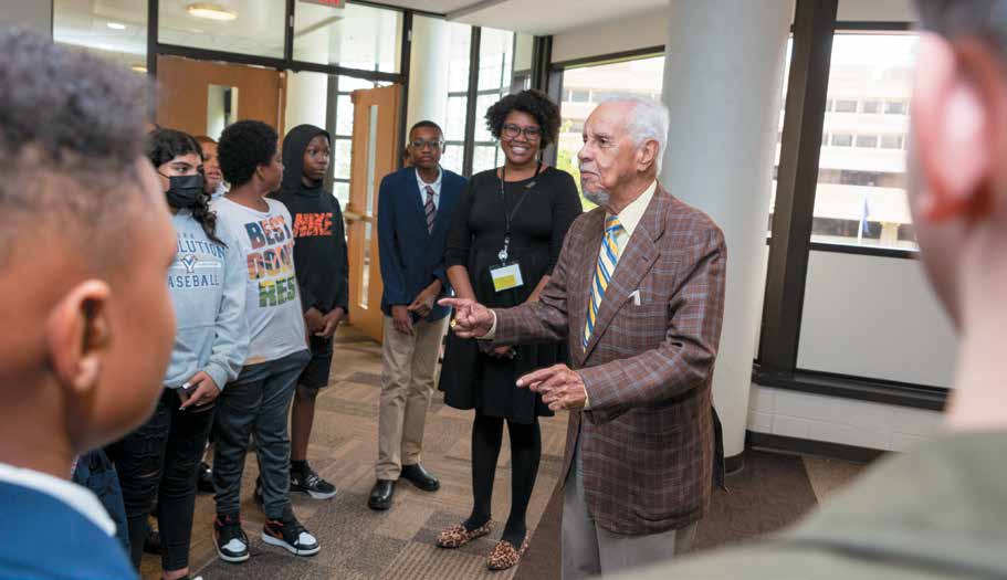 Governor Wilder talking to people in a circle